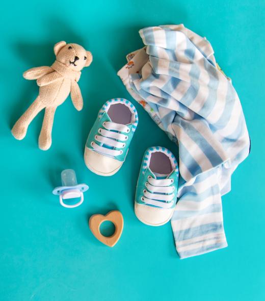 Baby clothes and accessories on the blue background. Selective focus. Nature.